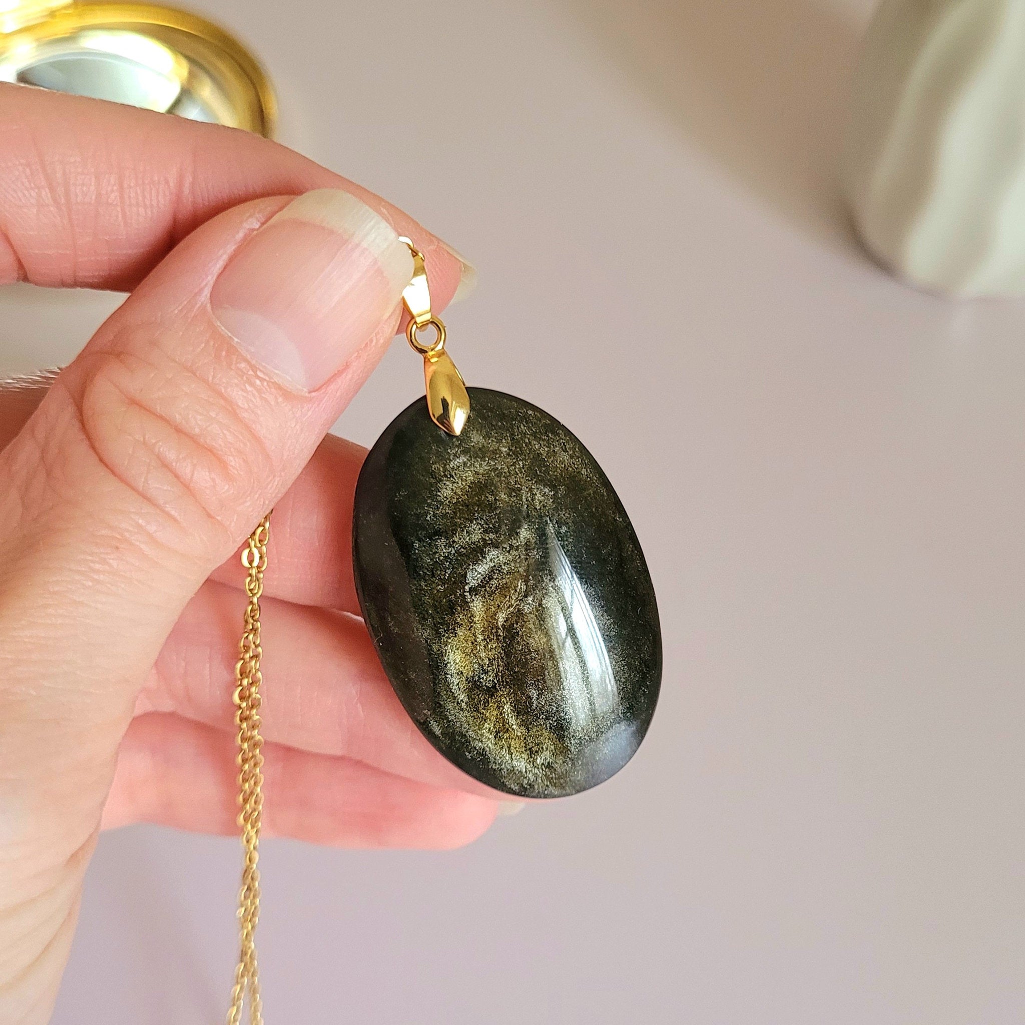 Pendentif obsidienne dorée 4,1 cm bélière dorée