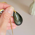 Pendentif obsidienne dorée 4,3 cm bélière dorée