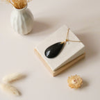 Pendentif obsidienne dorée 4,3 cm bélière dorée