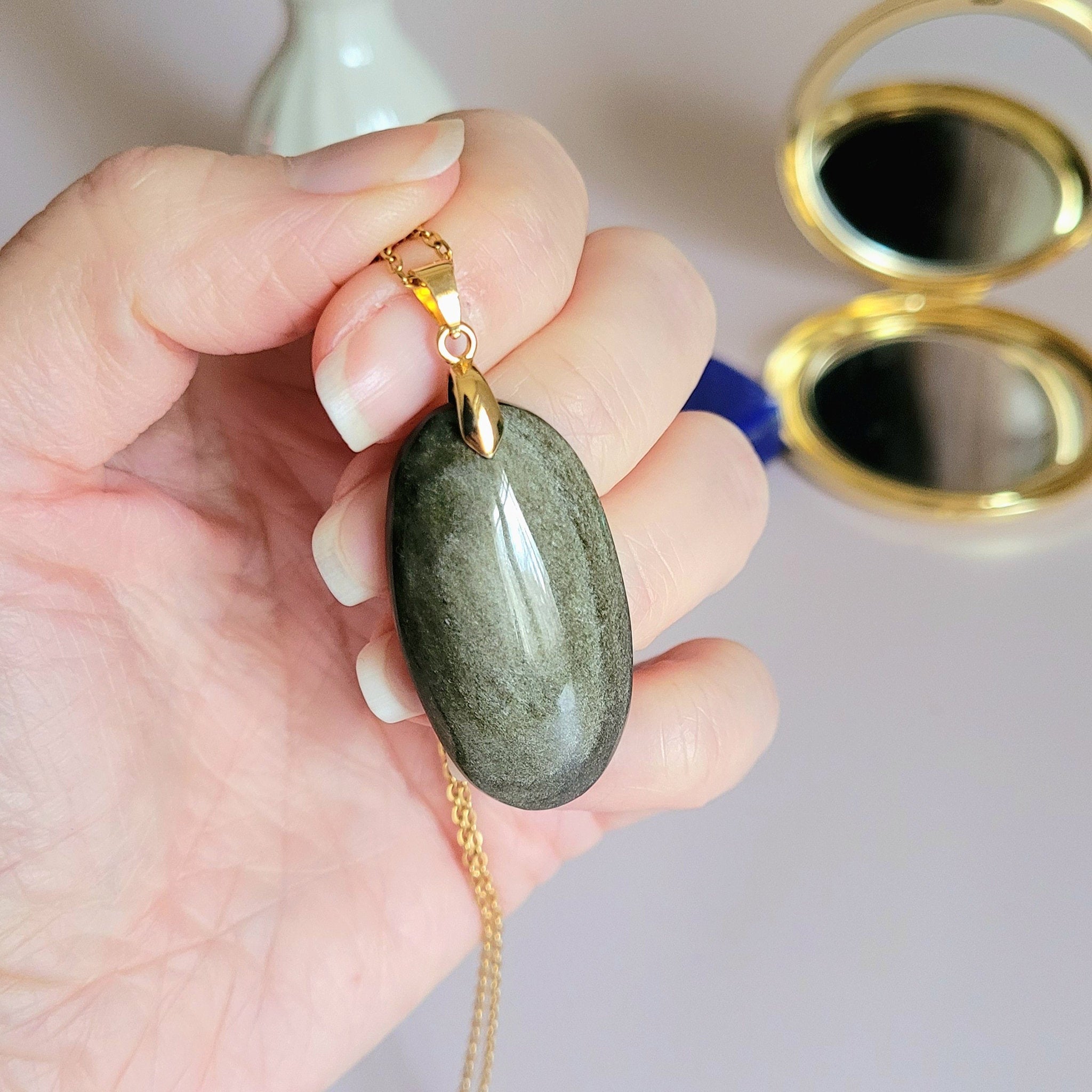 Pendentif obsidienne dorée 3,9 cm bélière dorée