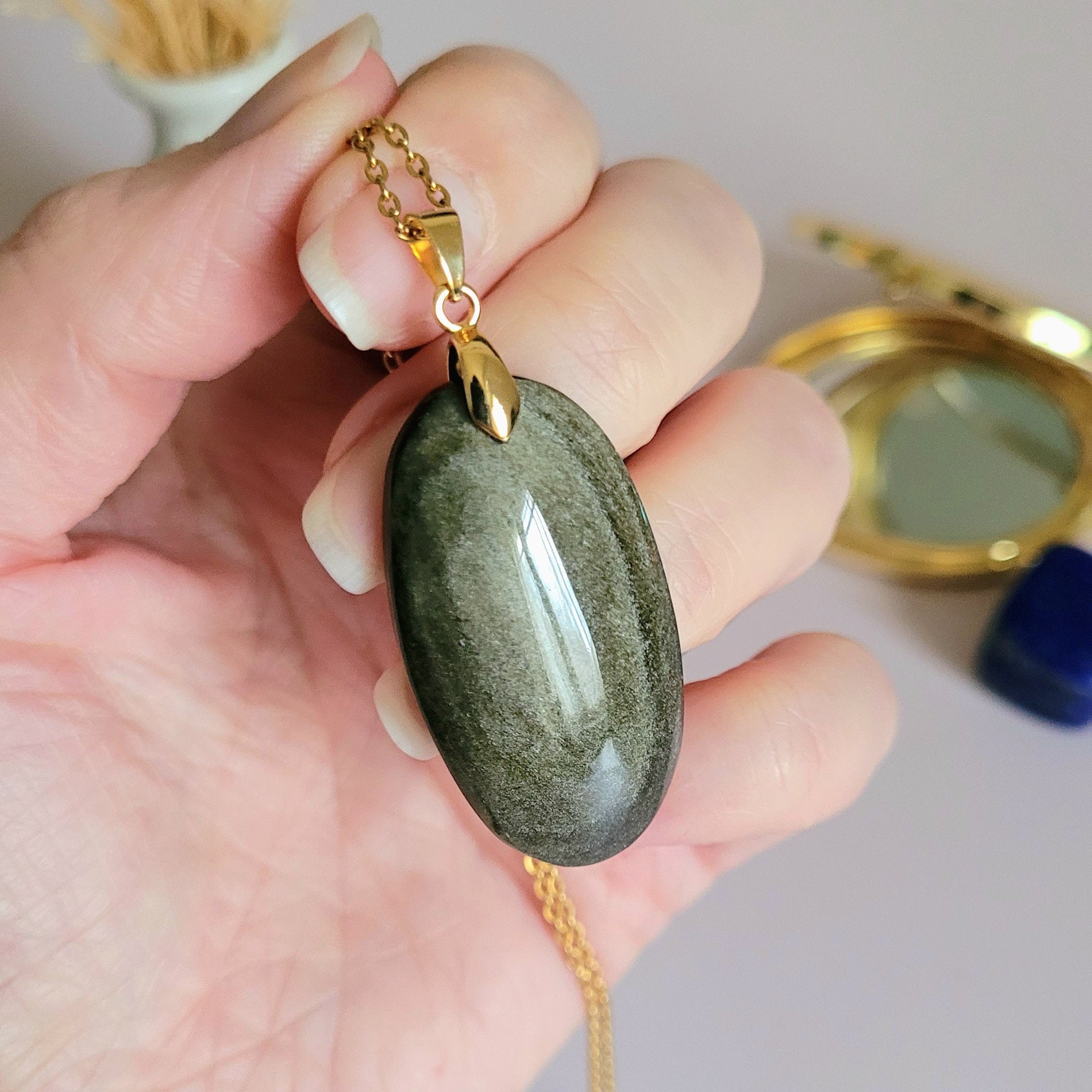 Pendentif obsidienne dorée 3,9 cm bélière dorée