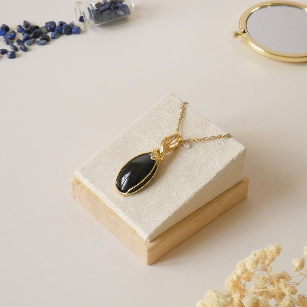 Pendentif obsidienne oeil céleste 4,8 cm wire wrapping doré