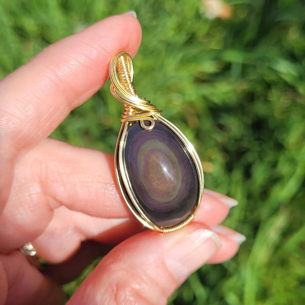 Pendentif obsidienne oeil céleste 4,6 cm wire wrapping doré