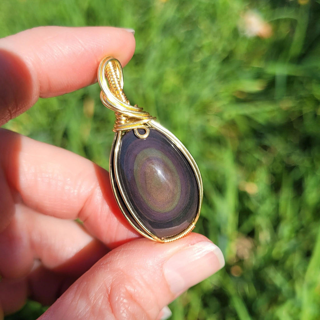 Pendentif obsidienne oeil céleste 4,6 cm wire wrapping doré
