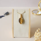 Pendentif oeil de tigre 4,4cm wire wrapping doré